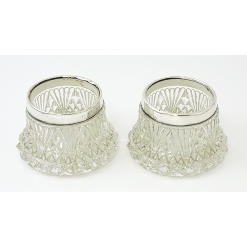 460 - A pair of cut glass salts with silver rims hallmarked London 1905. Approx. 2