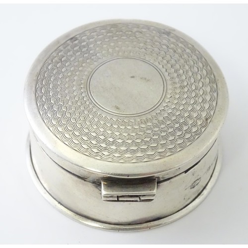 468 - A silver pill box of circular form with engine turned decoration, hallmarked Birmingham 1917, maker ... 