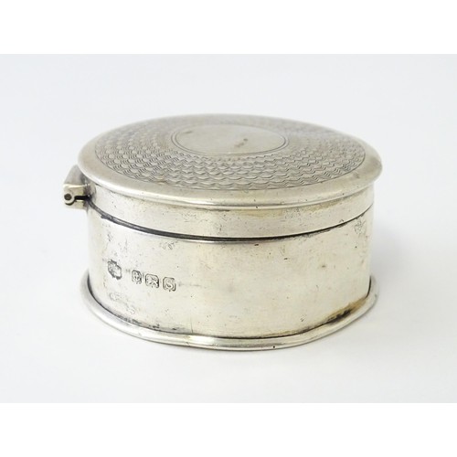 468 - A silver pill box of circular form with engine turned decoration, hallmarked Birmingham 1917, maker ... 