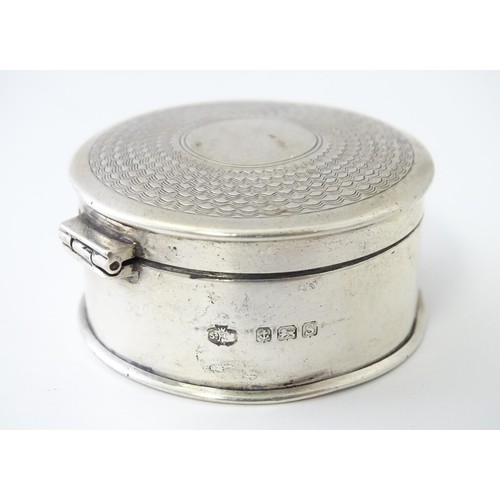 468 - A silver pill box of circular form with engine turned decoration, hallmarked Birmingham 1917, maker ... 