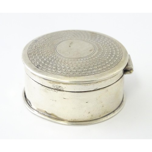 468 - A silver pill box of circular form with engine turned decoration, hallmarked Birmingham 1917, maker ... 