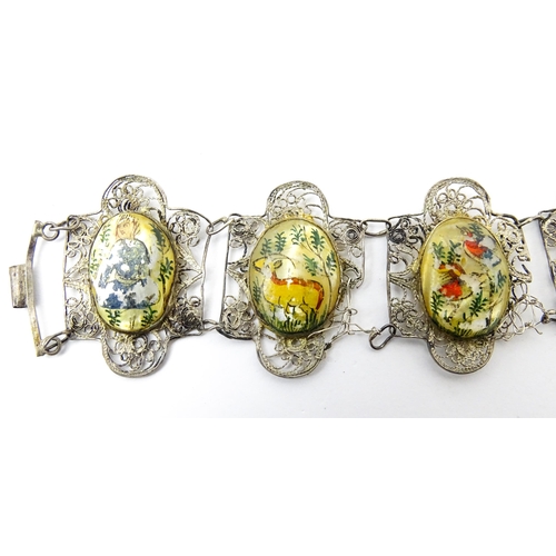 717 - An Indian white metal bracelet with hand painted mother of pearl panels. Approx. 7 1/2