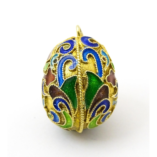 733 - A gilt metal fob / pendant of egg form with champleve enamel cross detail, in the Russian style. App... 