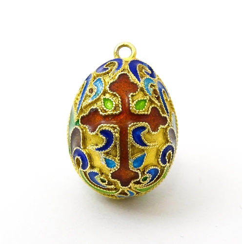 733 - A gilt metal fob / pendant of egg form with champleve enamel cross detail, in the Russian style. App... 