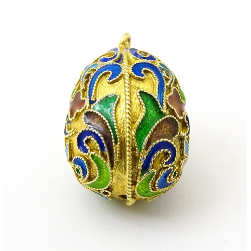 733 - A gilt metal fob / pendant of egg form with champleve enamel cross detail, in the Russian style. App... 