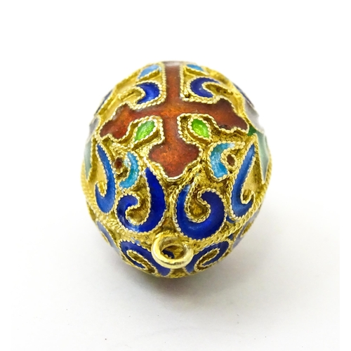 733 - A gilt metal fob / pendant of egg form with champleve enamel cross detail, in the Russian style. App... 