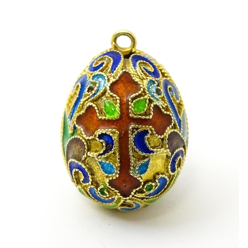 733 - A gilt metal fob / pendant of egg form with champleve enamel cross detail, in the Russian style. App... 