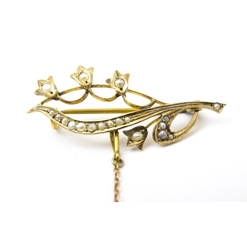 758 - A 9ct gold brooch of floral form set with seed pearls. Approx. 1 3/4