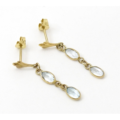 763 - A pair of yellow metal drop earrings set with aquamarine. Approx. 1