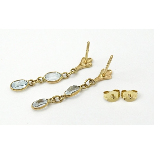 763 - A pair of yellow metal drop earrings set with aquamarine. Approx. 1