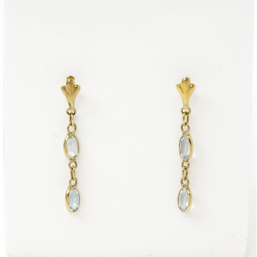 763 - A pair of yellow metal drop earrings set with aquamarine. Approx. 1