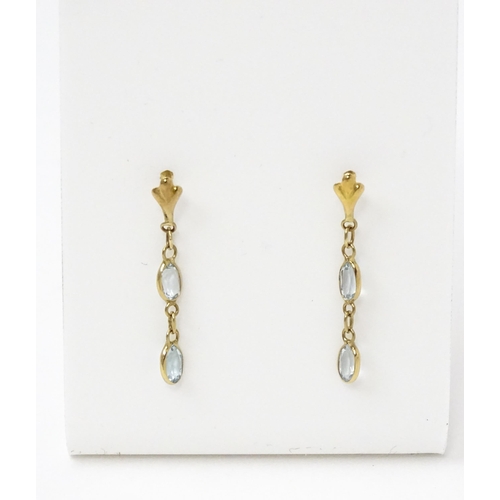 763 - A pair of yellow metal drop earrings set with aquamarine. Approx. 1