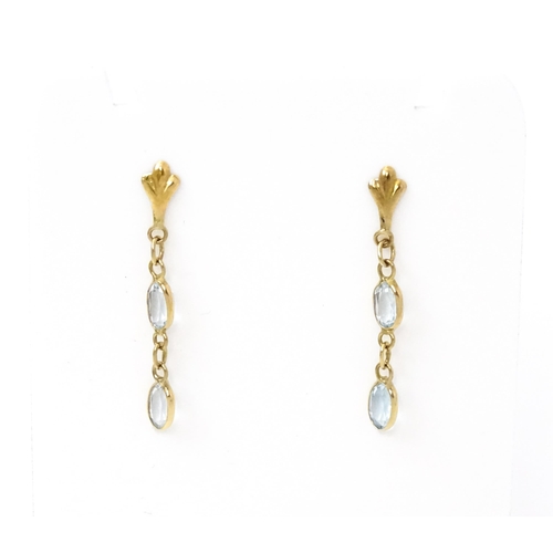 763 - A pair of yellow metal drop earrings set with aquamarine. Approx. 1