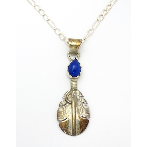 772 - Native American Indian interest: A silver pendant of feather form with lapis lazuli cabochon by Lena... 