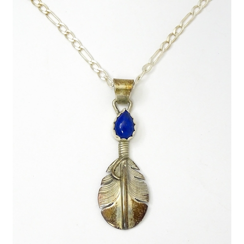 772 - Native American Indian interest: A silver pendant of feather form with lapis lazuli cabochon by Lena... 