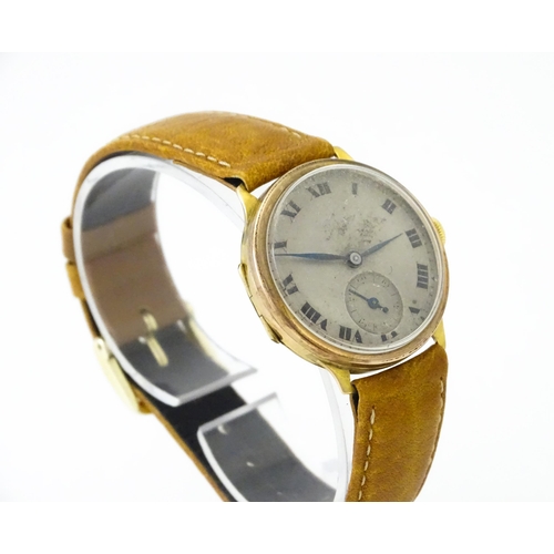 813 - A 9ct gold cased manual wristwatch, the silvered dial with Roman numerals and subsidiary seconds dia... 