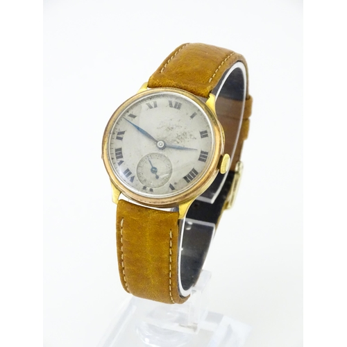 813 - A 9ct gold cased manual wristwatch, the silvered dial with Roman numerals and subsidiary seconds dia... 