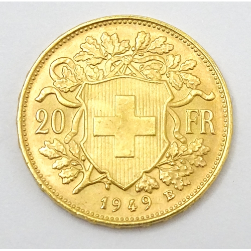 832 - Collector's coin: a boxed 1949 gold Swiss 20 Francs / Vreneli coin, approx 3/4