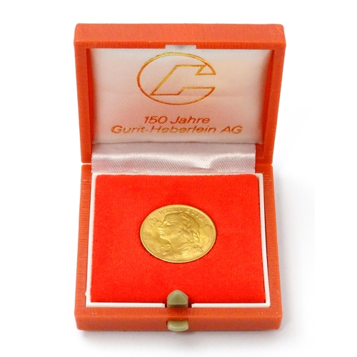 832 - Collector's coin: a boxed 1949 gold Swiss 20 Francs / Vreneli coin, approx 3/4