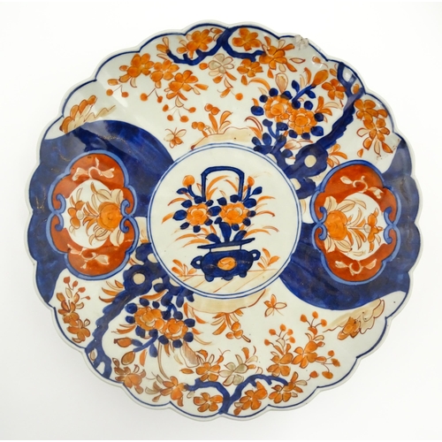 40 - Three various Japanese chargers to include an example decorated in the Imari palette with fan shaped... 