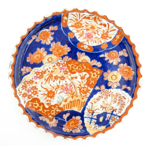 40 - Three various Japanese chargers to include an example decorated in the Imari palette with fan shaped... 