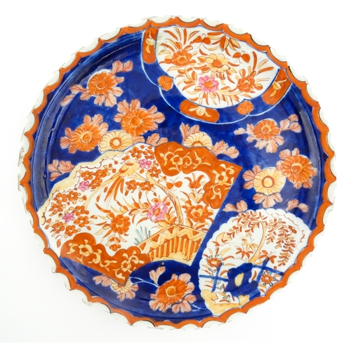 40 - Three various Japanese chargers to include an example decorated in the Imari palette with fan shaped... 