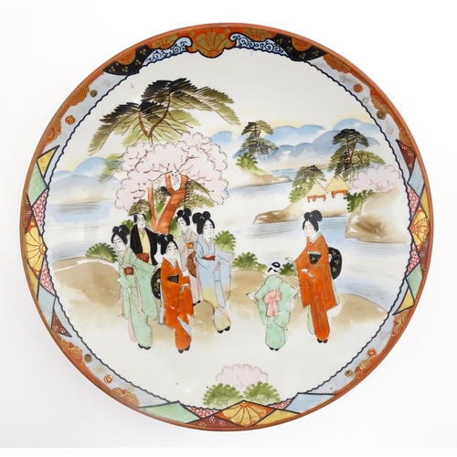 40 - Three various Japanese chargers to include an example decorated in the Imari palette with fan shaped... 