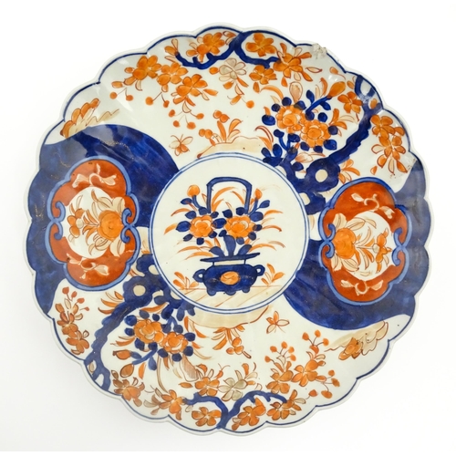 40 - Three various Japanese chargers to include an example decorated in the Imari palette with fan shaped... 