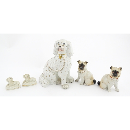 48 - Five assorted pottery models of dogs to include two Staffordshire pottery seated poodles, a seated s... 