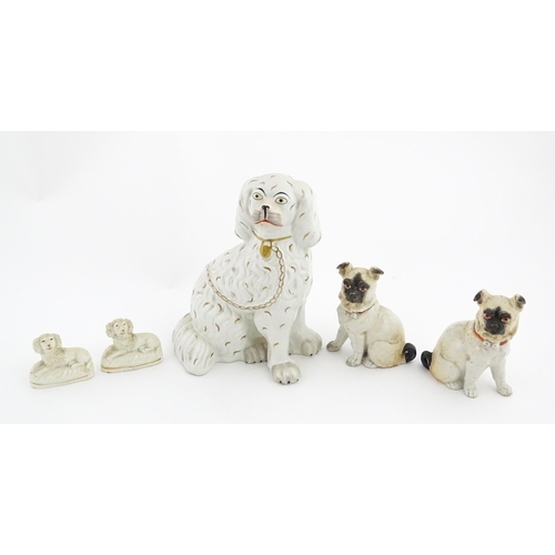 48 - Five assorted pottery models of dogs to include two Staffordshire pottery seated poodles, a seated s... 