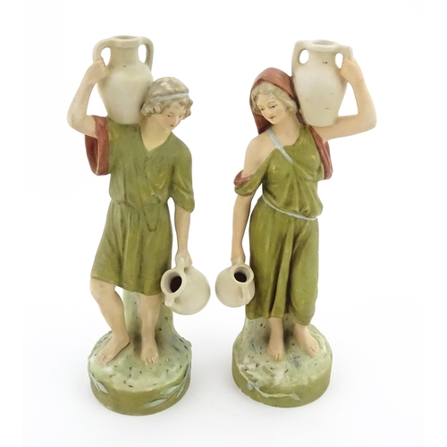 55 - A pair of Royal Dux classical water carrier figures depicting a male and female carrying water vases... 