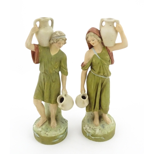 55 - A pair of Royal Dux classical water carrier figures depicting a male and female carrying water vases... 