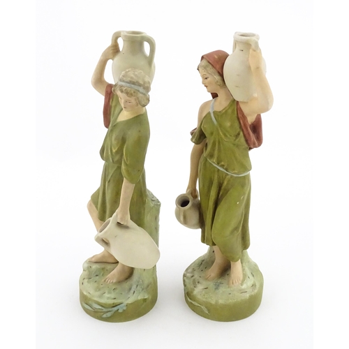 55 - A pair of Royal Dux classical water carrier figures depicting a male and female carrying water vases... 