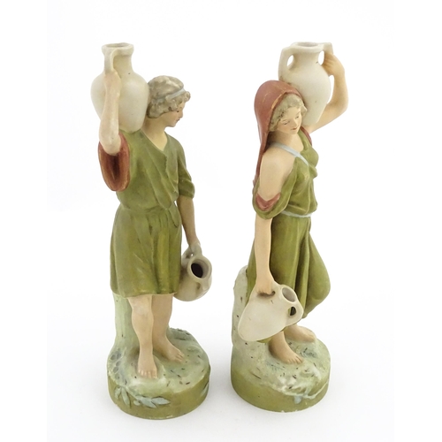 55 - A pair of Royal Dux classical water carrier figures depicting a male and female carrying water vases... 