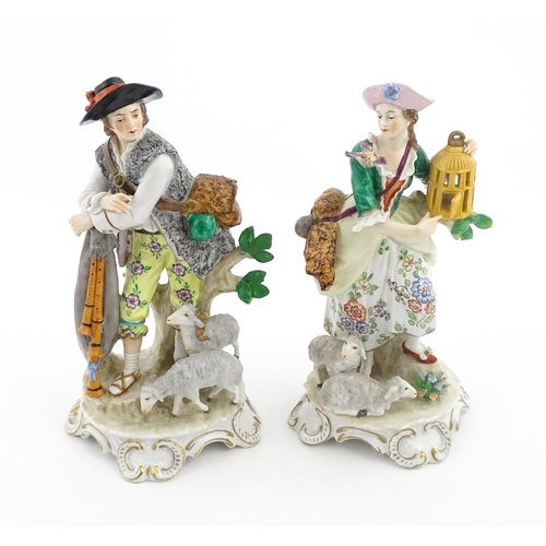 56 - A pair of Sitzendorf figures modelled as shepherd and shepherdess, both with sheep, the female figur... 