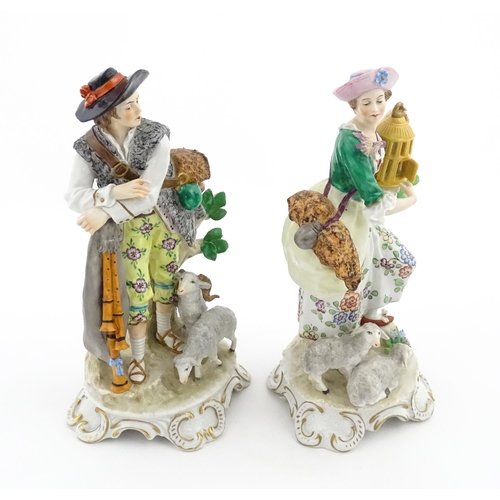 56 - A pair of Sitzendorf figures modelled as shepherd and shepherdess, both with sheep, the female figur... 