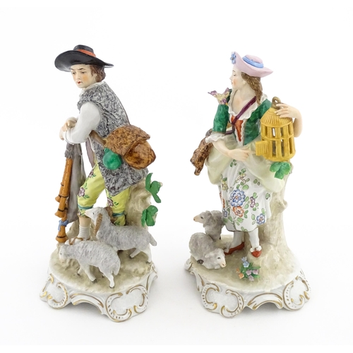 56 - A pair of Sitzendorf figures modelled as shepherd and shepherdess, both with sheep, the female figur... 