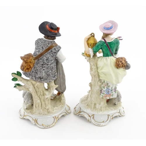 56 - A pair of Sitzendorf figures modelled as shepherd and shepherdess, both with sheep, the female figur... 