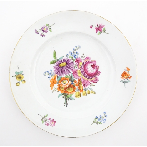 57 - A Meissen cabinet plate with hand painted decoration depicting a central floral spray further border... 