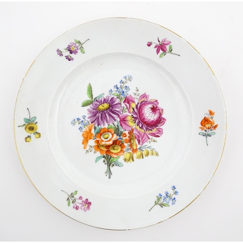 57 - A Meissen cabinet plate with hand painted decoration depicting a central floral spray further border... 