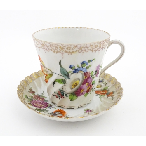 58 - A Dresden Donath & Co. cup and saucer with hand painted decoration depicting flowers and foliage, wi... 