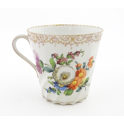 58 - A Dresden Donath & Co. cup and saucer with hand painted decoration depicting flowers and foliage, wi... 