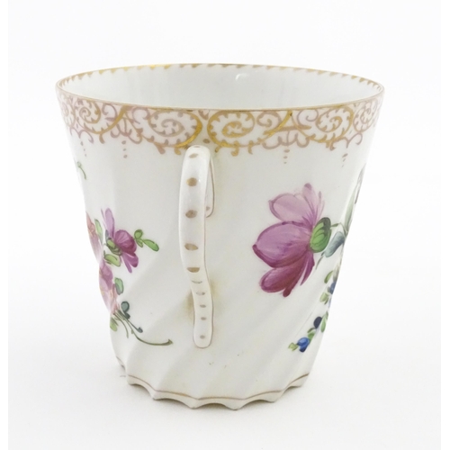 58 - A Dresden Donath & Co. cup and saucer with hand painted decoration depicting flowers and foliage, wi... 