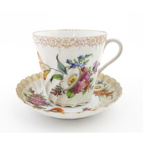 58 - A Dresden Donath & Co. cup and saucer with hand painted decoration depicting flowers and foliage, wi... 