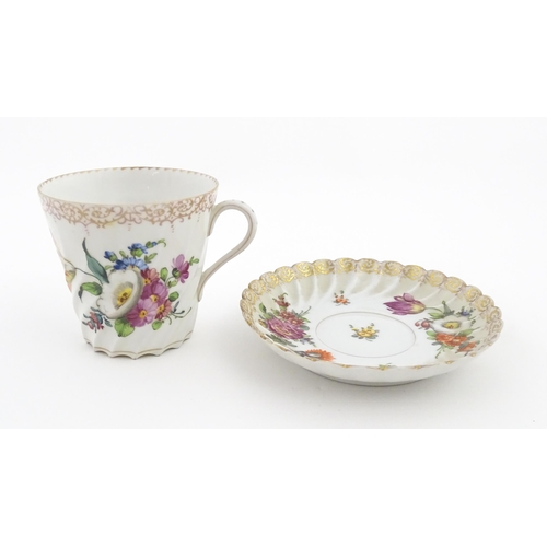 58 - A Dresden Donath & Co. cup and saucer with hand painted decoration depicting flowers and foliage, wi... 