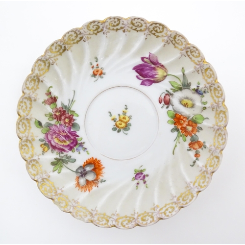 58 - A Dresden Donath & Co. cup and saucer with hand painted decoration depicting flowers and foliage, wi... 