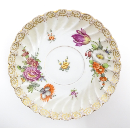 58 - A Dresden Donath & Co. cup and saucer with hand painted decoration depicting flowers and foliage, wi... 