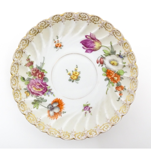 58 - A Dresden Donath & Co. cup and saucer with hand painted decoration depicting flowers and foliage, wi... 