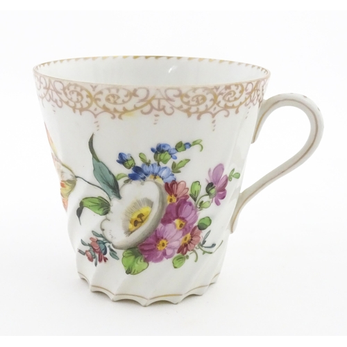 58 - A Dresden Donath & Co. cup and saucer with hand painted decoration depicting flowers and foliage, wi... 