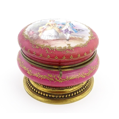 60 - A Sevres porcelain jewellery / trinket box of circular form, the lid decorated with hand painted cou... 